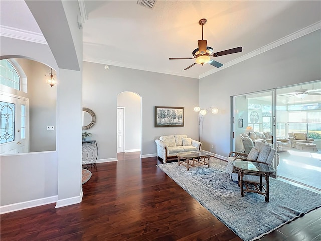 living room with dark hardwood / wood-style flooring, crown molding, plenty of natural light, and ceiling fan