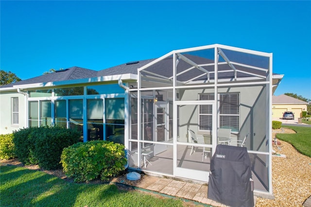 rear view of property featuring a lanai