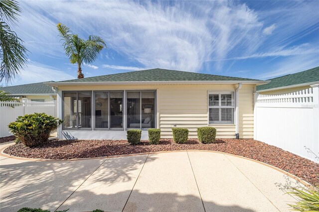 rear view of house with a sunroom and a patio area