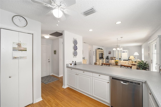 kitchen with white cabinetry, dishwasher, decorative light fixtures, ceiling fan with notable chandelier, and light wood-type flooring