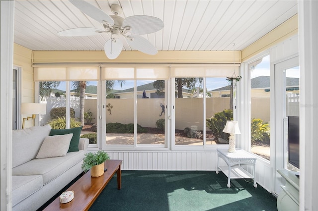 sunroom / solarium with plenty of natural light, wooden ceiling, and ceiling fan