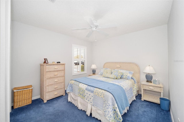 carpeted bedroom featuring ceiling fan and a textured ceiling