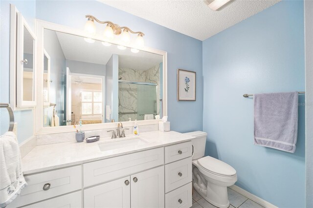 bathroom with vanity, a textured ceiling, a shower with door, tile patterned flooring, and toilet