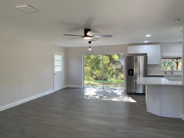 kitchen with plenty of natural light, white cabinetry, stainless steel fridge with ice dispenser, and ceiling fan