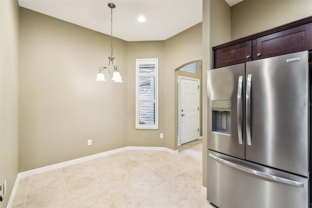 kitchen featuring stainless steel fridge with ice dispenser, light tile patterned floors, decorative light fixtures, dark brown cabinets, and a chandelier