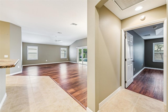 foyer entrance with ceiling fan, light hardwood / wood-style flooring, and lofted ceiling