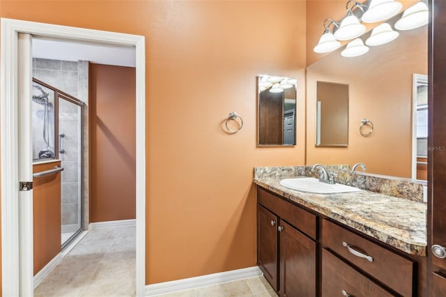 bathroom with tile patterned floors, vanity, and an enclosed shower