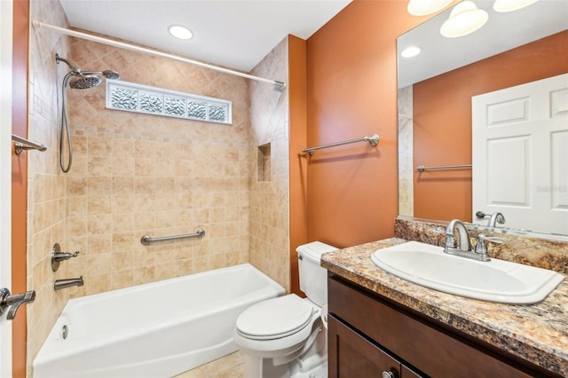 full bathroom featuring tile patterned flooring, toilet, vanity, and tiled shower / bath