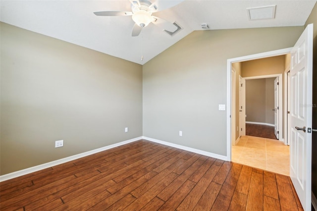 spare room with vaulted ceiling, light hardwood / wood-style flooring, and ceiling fan