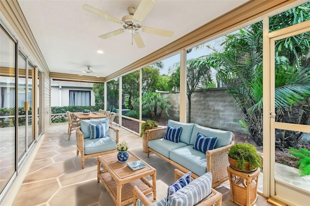 sunroom / solarium featuring ceiling fan