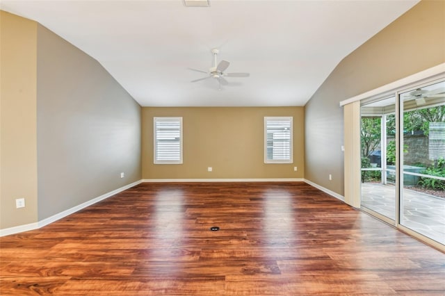 empty room featuring vaulted ceiling, ceiling fan, and dark hardwood / wood-style floors