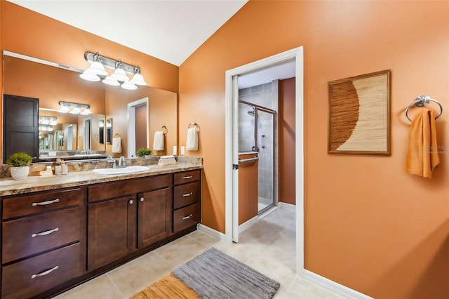 bathroom featuring tile patterned floors, vanity, lofted ceiling, and walk in shower