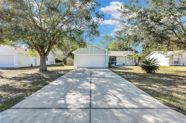 ranch-style house with a garage and a front lawn