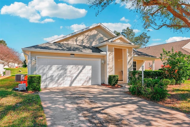 view of front of property featuring a garage and cooling unit