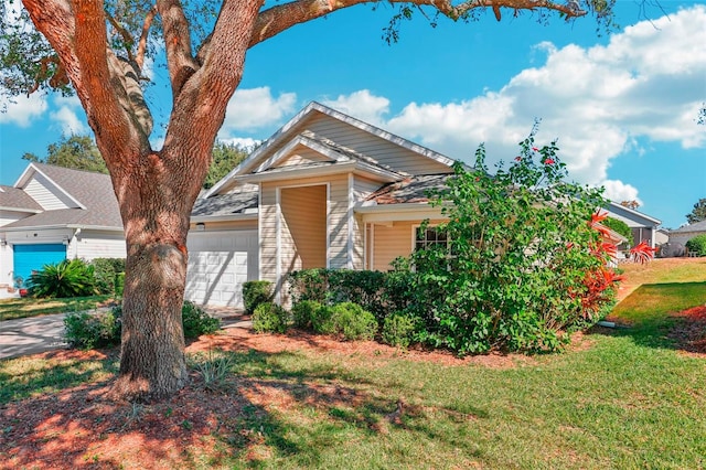 view of front of property with a front yard and a garage