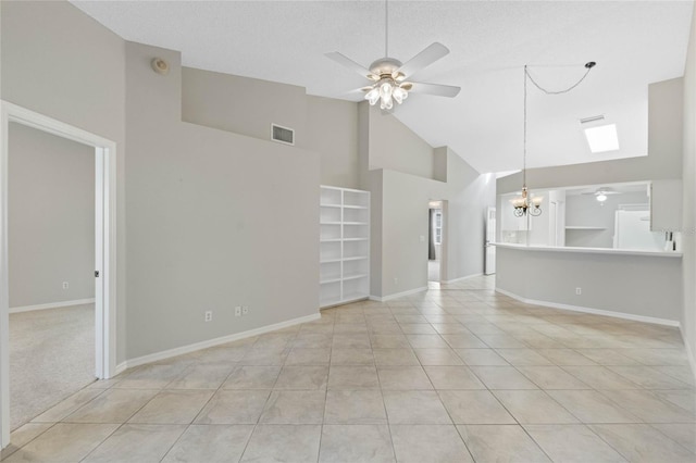 unfurnished living room featuring ceiling fan with notable chandelier, light tile patterned floors, and high vaulted ceiling