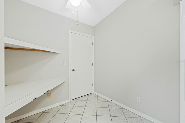 interior space featuring light tile patterned floors, vaulted ceiling, and ceiling fan