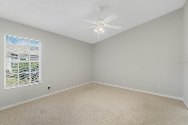 empty room with light carpet, ceiling fan, and a healthy amount of sunlight