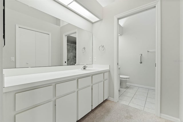 bathroom with tile patterned flooring, vanity, and toilet