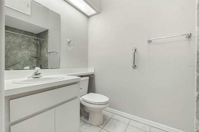 bathroom featuring toilet, a tile shower, vanity, and tile patterned floors