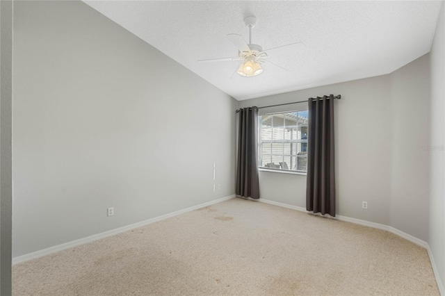 spare room featuring a textured ceiling, light colored carpet, ceiling fan, and lofted ceiling