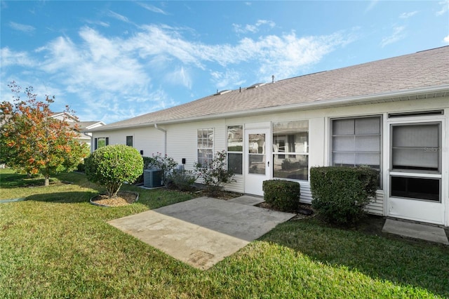 back of house with a lawn, a patio, and central AC