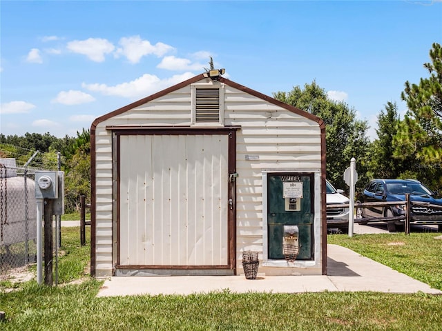 view of outbuilding with a yard