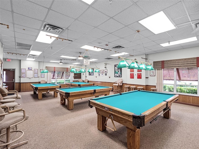 recreation room with carpet flooring, pool table, a drop ceiling, and wood walls