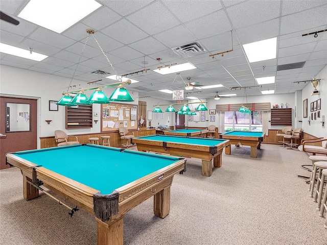 game room featuring carpet flooring, ceiling fan, and a paneled ceiling