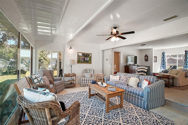 living room with ceiling fan and a healthy amount of sunlight