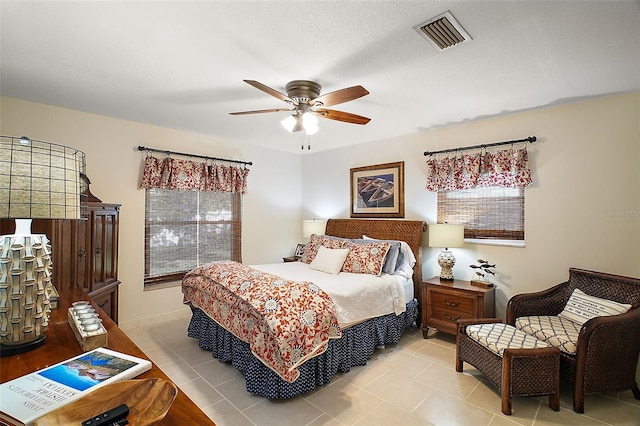 tiled bedroom featuring ceiling fan