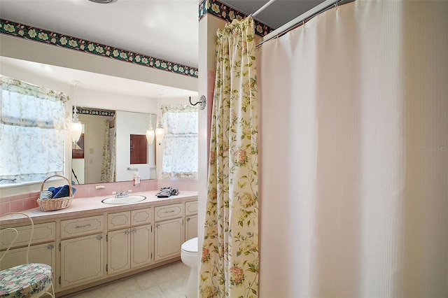 bathroom featuring tile patterned floors, vanity, and toilet