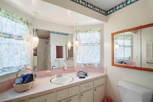 bathroom featuring vanity and toilet