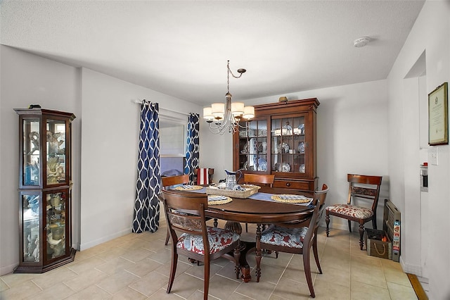 dining room featuring light tile patterned floors and a chandelier