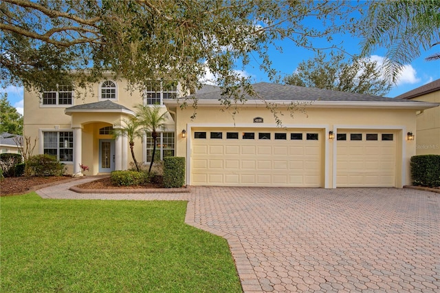 view of front of property featuring a front lawn and a garage