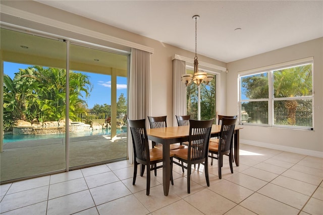 tiled dining area featuring an inviting chandelier