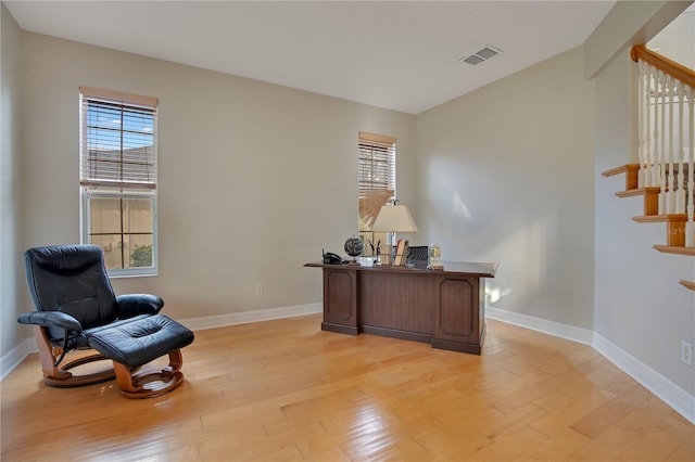 office with a healthy amount of sunlight and light hardwood / wood-style flooring