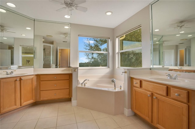 bathroom with tile patterned floors, vanity, and separate shower and tub