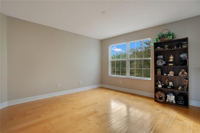 unfurnished room with light wood-type flooring