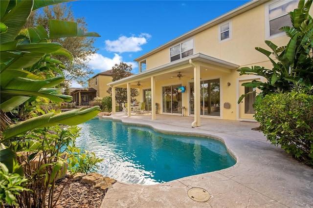 view of swimming pool with ceiling fan and a patio