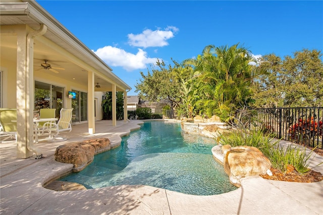 view of swimming pool with ceiling fan, pool water feature, and a patio