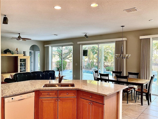 kitchen featuring a wealth of natural light, dishwasher, and a textured ceiling