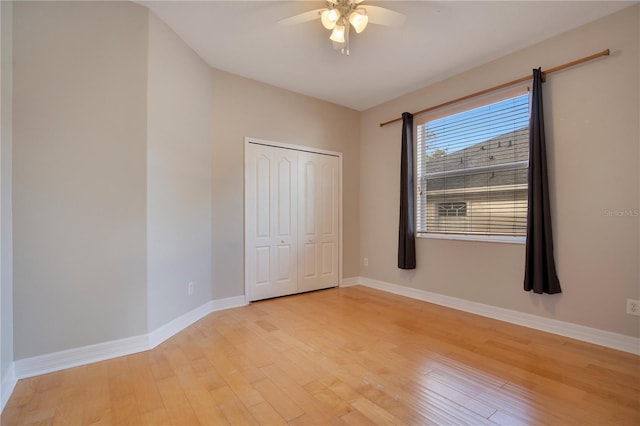 unfurnished bedroom featuring ceiling fan, a closet, and light hardwood / wood-style floors