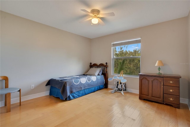 bedroom with ceiling fan and light hardwood / wood-style floors