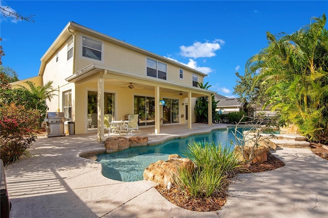 back of house featuring a patio area, ceiling fan, and an outdoor kitchen