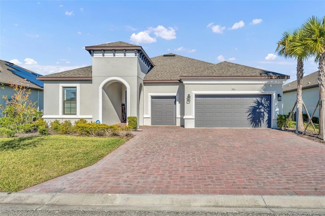 view of front of home with a garage and a front lawn