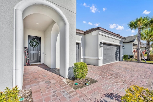 view of exterior entry featuring a garage