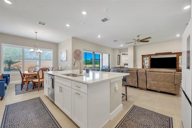 kitchen featuring pendant lighting, a center island with sink, sink, a healthy amount of sunlight, and white cabinetry