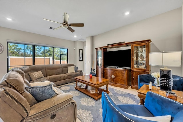 living room with ceiling fan and light tile patterned flooring