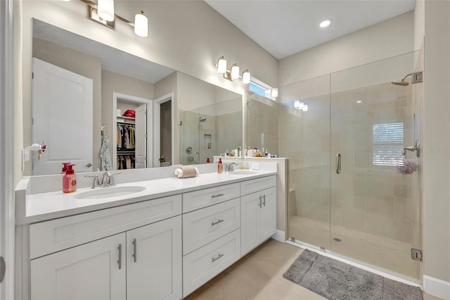 bathroom featuring vanity and an enclosed shower